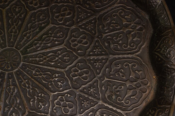 A bronze tray with geometric figures in the traditional execution of oriental culture