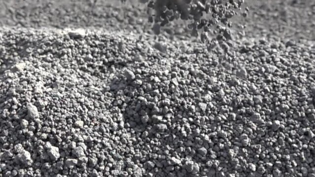 Volcanology. That there is pyroclastic material (volcanic slag). Particles of frozen (solidification of melt) foamy (gas emissions) lava and fuse volcanic ash move, fall in frame. Super slow motion
