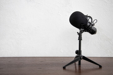 Studio Condenser Microphone for home studio radio podcast isolated on white wall wooden table...