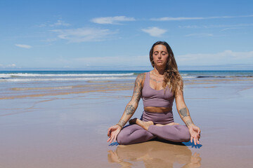 Fototapeta na wymiar person meditating on the beach