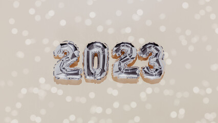 Christmas or New Year background. Beige banner, silver 2023 baloon numbers