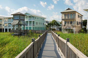 Destin, Florida- Boardwalk over the tall grass plants near the lake and residences