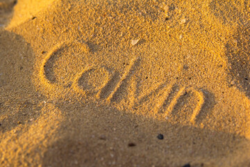 photo background sand with a footprint in the form of an inscription of letters, a blurry natural look