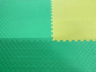 Green and yellow rubber mat for sports and children's playground