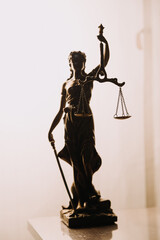 Justice and law concept.Male judge in a courtroom with the gavel, working with, computer and docking keyboard, eyeglasses, on table in morning light