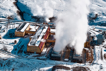 Aerial view to geothermal power plant in mountain. Clean renewable green energy in Kamchatka.