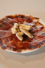 close up view of a plate of serrano ham with spikes, classic spanish
