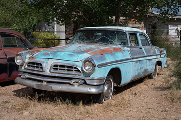 Old blue 1955 car abandoned in the yard