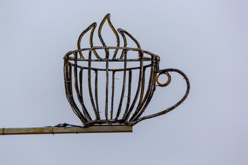 Large metal mug on a white background, invites you to coffee