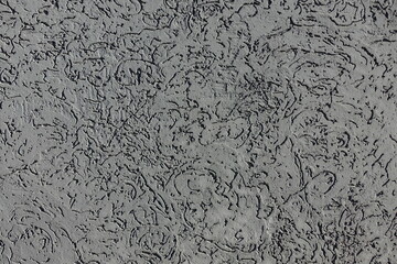 Texture of dark gray wall with stucco worm finish