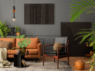Cozy living room interior with mock up poster frame, brown sofa, leather armchair, black coffee table, books, plants in flowerpots. gray carpet, pillows and personal accessories. Home decor. Template.
