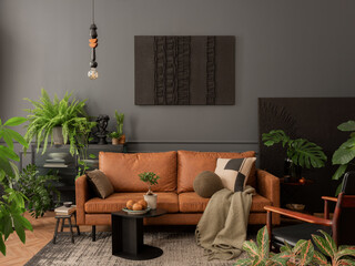 Aesthetic interior of living room with mock up poster frame, brown sofa, plants, black coffee...