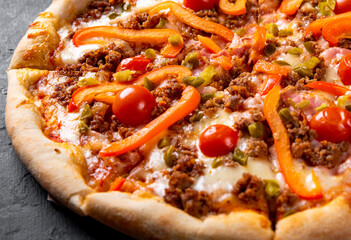Pizza with Mozzarella cheese, Bolognese sauce, minced meat, pepper, tomato, bacon and vegetables