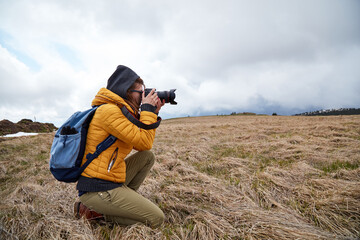 Young woman photographer enjoying in nature.