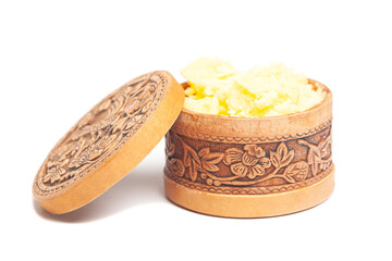 Ghee in wooden bowl isolated on white background