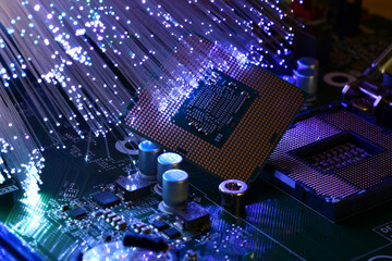 Detail of CPU on a PC Motherboard illuminated by a lampada a fibre ottiche. High tech technology...
