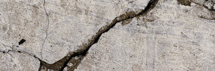 Texture of old cracked concrete wall. Rough gray concrete surface. Wide panoramic background for design.