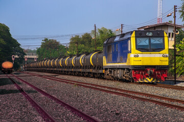 Fototapeta premium Tanker-freight train by diesel locomotive on the railway.