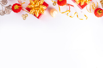 Chinese New Year on white background. Lunar New Year greeting card with traditional festival decoration - ginkgo biloba, golden twigs, gift boxes, red berries, gift envelopes, coins, chinese lanterns