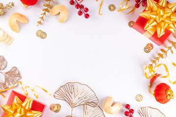 Chinese New Year on white background. Lunar New Year greeting card with traditional festival decoration - ginkgo biloba, golden twigs, gift boxes, red berries, gift envelopes, coins, chinese lanterns