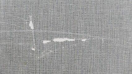 Scraped and scuffed pale grey wallpaper with space for copy