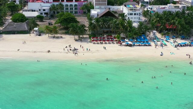 aerial of crystal clear turquoise blue water in Playa Del Carmen with beachfront hotels and resorts in Mexico