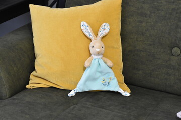 Posing the rabbit puppet lying on the couch.