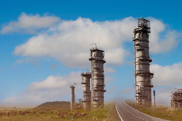 The  road way with oil refinery plant form industry zone ,which the factory - petrochemical plant as blue sky background