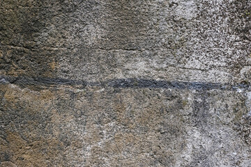 Old concrete wall with cracks and black and green mold grunge background and wallpaper texture