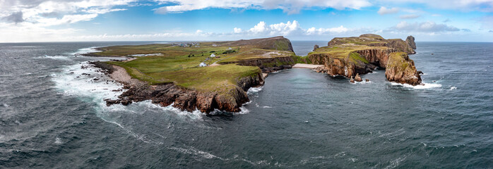 The cliffs and sea stacks An Tor Mor and the Wishing Stone at Port Challa on Tory Island, County...