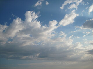 Blue sky with clouds. Scenic panoramic view with sunrise over the sea. Time lapse of clouds over the mountains. Natural beauty of sky and fluffy morning clouds.