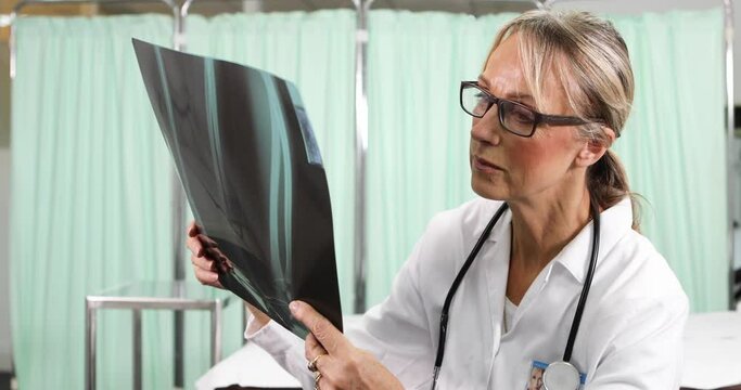 Female doctor in hosptal looking at x-ray