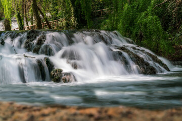 Fototapeta na wymiar waterfall with silky water inside the stone monastery. Zaragoza. Spain