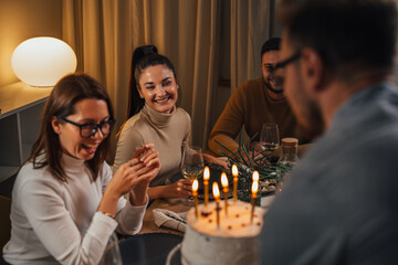 Man brings the cake to the birthday girl