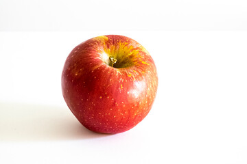 A fresh red apple on a white background.