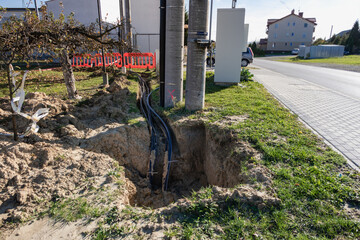 Thick power cable in the ground - electrical tunnel at the high voltage pole