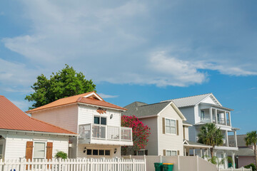 Facade of fenced suburban houses with wood wall sidings in Destin, Florida