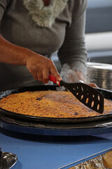 Market vendor sells socca, a traditional dish from the south of France