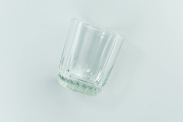 empty glass cup on a light gray background