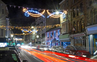 Long exposure image of High Street of Ilfracombe illuminated at night with Christmas lights 
