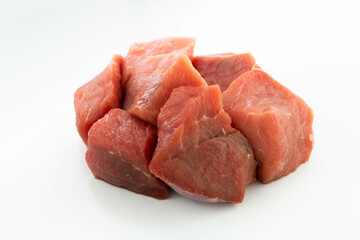 fresh raw meat cubes isolated on a white bacground