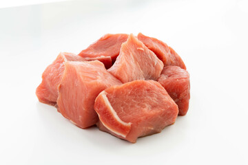 fresh raw meat cubes isolated on a white bacground