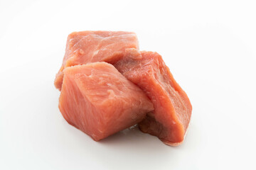 fresh raw meat cubes isolated on a white bacground