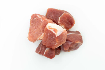 fresh raw meat cubes isolated on a white bacground top view