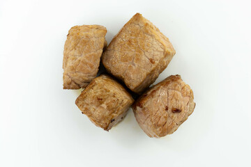 fresh baked meat cubes isolated on a white bacground top view