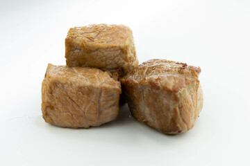 fresh baked meat cubes isolated on a white bacground