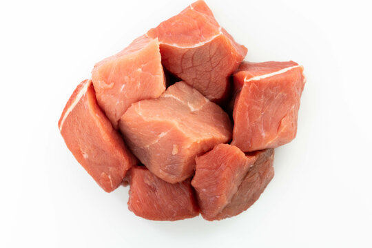 fresh raw meat cubes isolated on a white bacground top view