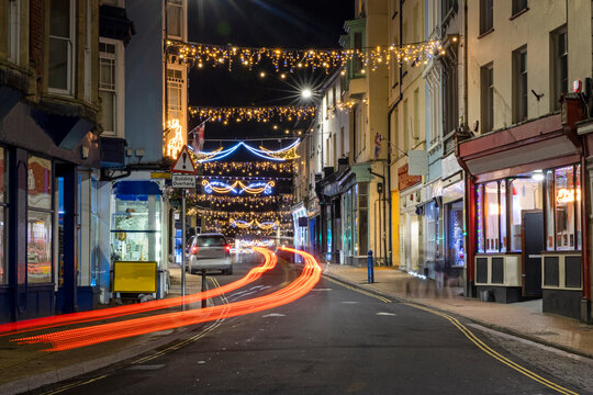 Long exposure image of High Street of Ilfracombe illuminated at night with Christmas lights 