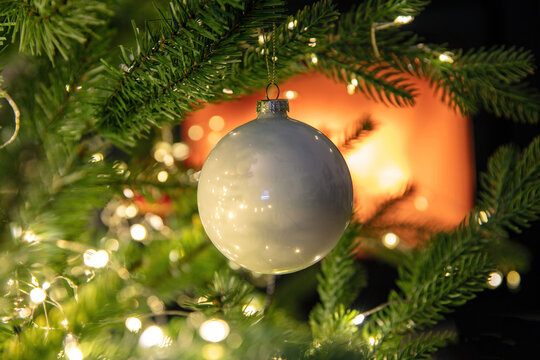 Christmas tree decoration bauble and lights close up, burning fireplace background