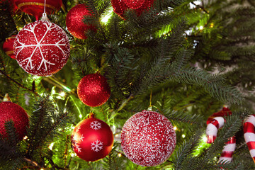 Christmas background. Xmas tree decoration red baubles and lights close up